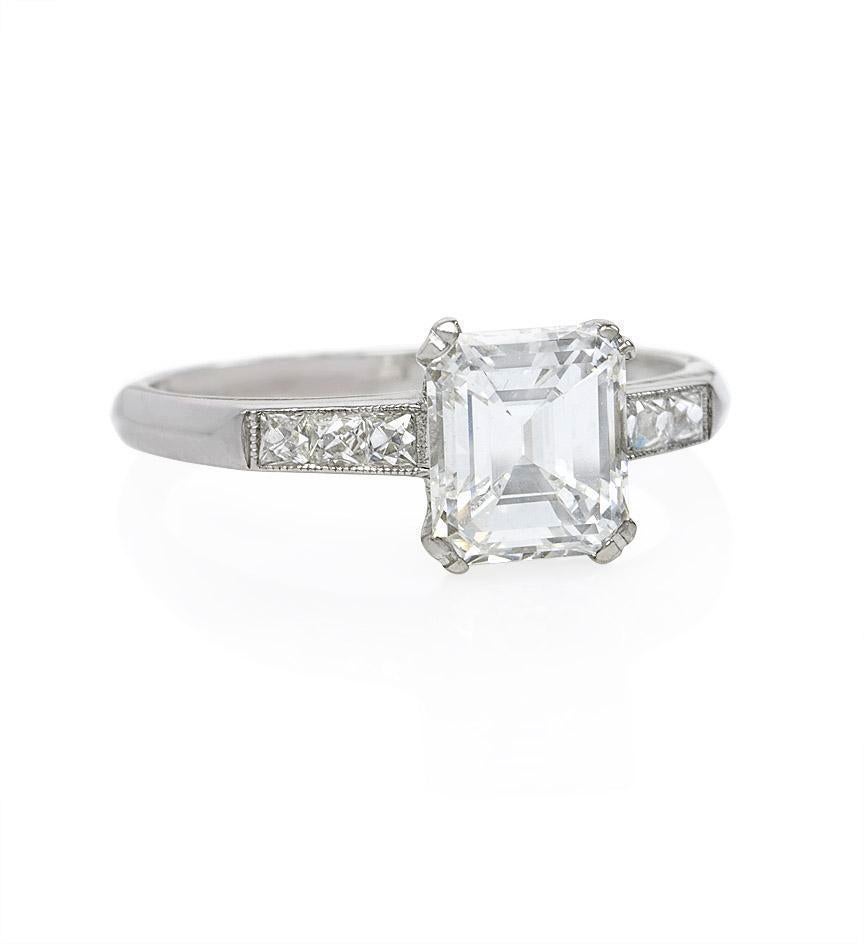 An Art Deco emerald cut diamond engagement ring, the center diamond weighing 1.03ct., E color, VVS2 clarity (GIA #2135868511), bordered by six French-cut diamonds, in platinum.