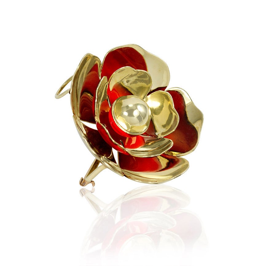 A Retro gold and reflective red enamel brooch with pendant loop in the form of a flower, in 14k. Cartier, New York.  See Patent #2199222.