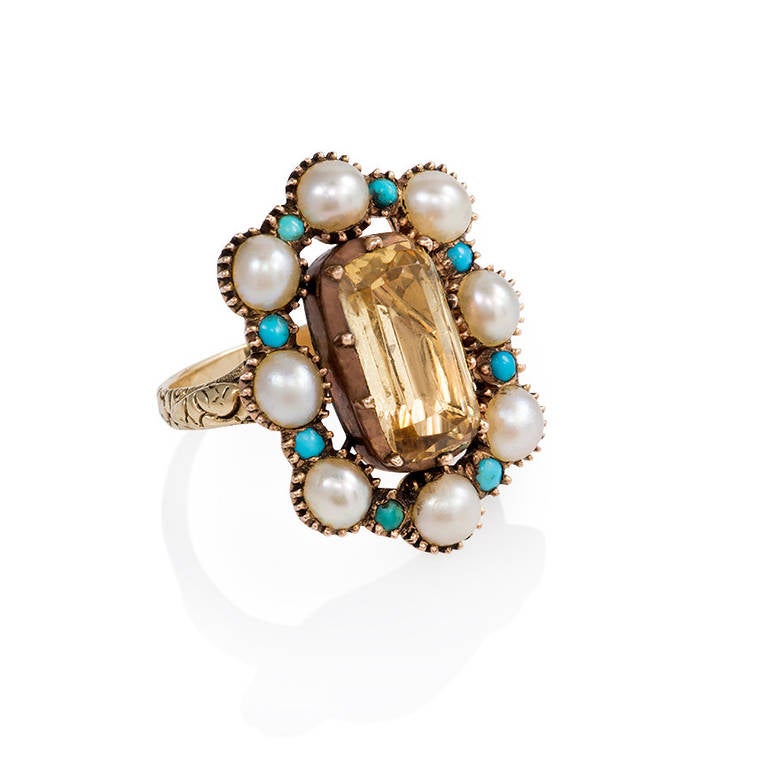 An antique gold cluster ring of pearl and turquoise set with a central lozenge-shaped topaz, in 15k. England.