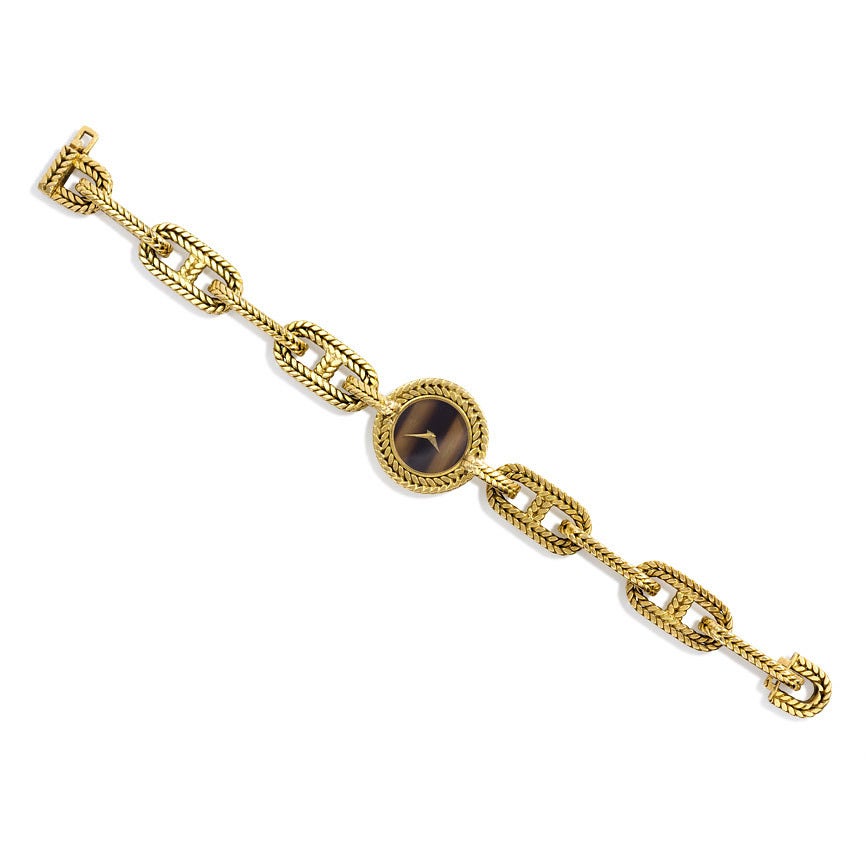 A gold braided anchor link backwinder watch with round tiger's eye face, in 18k. Georges L'Enfant for Hermès, Paris; #46877.  Baume & Mercier movement.