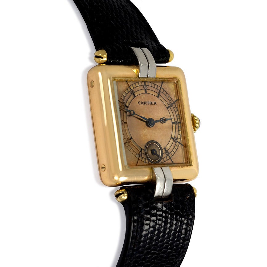 A Retro rose gold and platinum watch with a square bezel and ruby winding stem, the face inset with a seconds display, in 18k and platinum, with leather strap and deployant clasp.  Cartier, London.