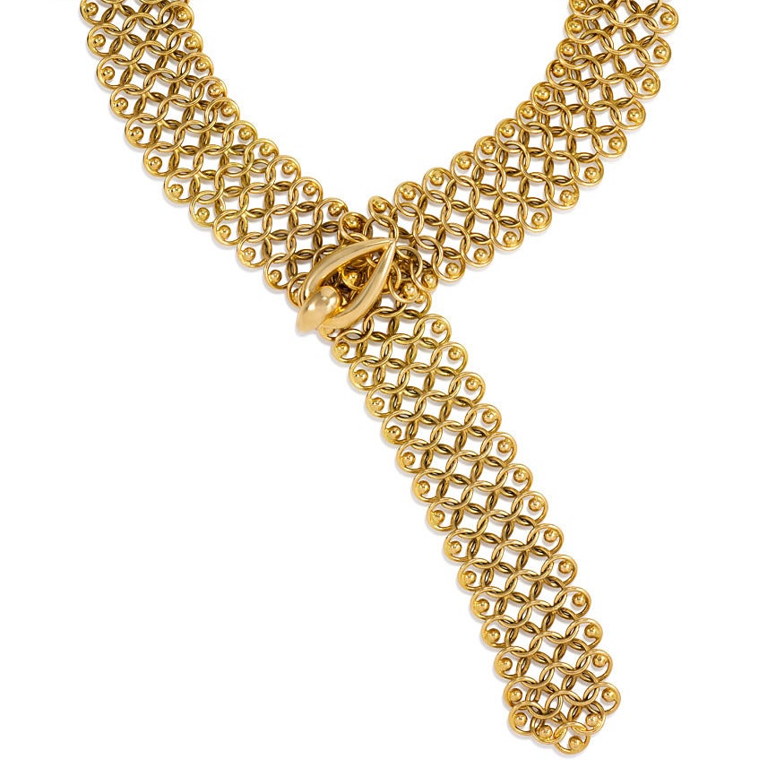 A gold mesh lariat syle necklace with beaded borders and drop shaped closure, in 18k. Cartier, Paris #07238.