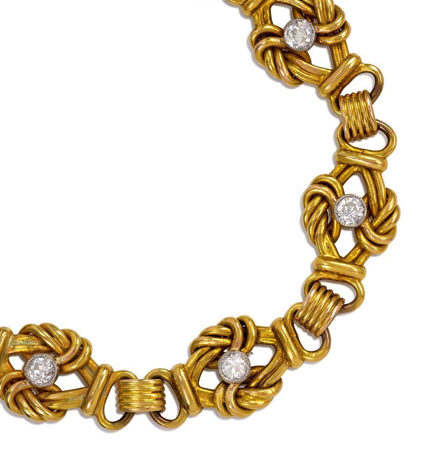 An early 20th century gold bracelet of knotted links with collet-set diamond centers and ribbed intersections, in 18k.