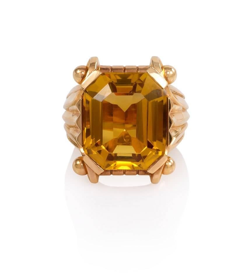 A Retro citrine and rose gold cocktail ring, the octagonal citrine set within a fluted shank with scrolled borders, in 18k.