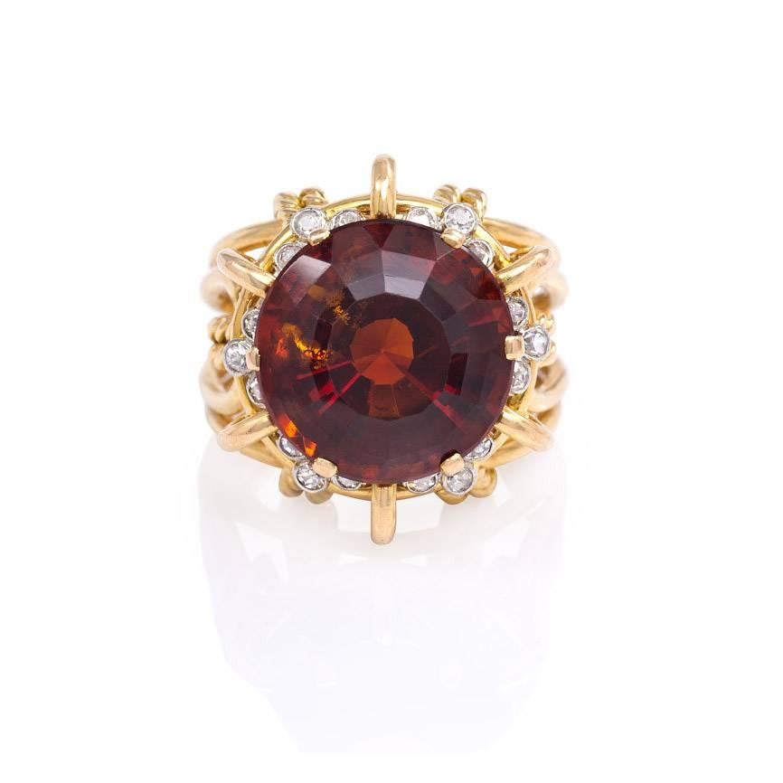 A gold wirework cocktail ring set with a madeira citrine and a surround of collet set diamonds, in 18k and platinum.  Mellerio dits Meller, Paris.
Vertical measurement of top of ring: 20mm; ring sits 12mm above hand.