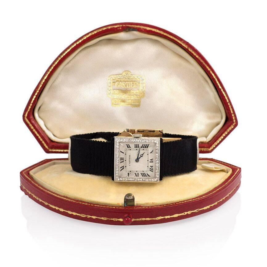An Art Deco diamond square-faced watch on a black grosgrain ribbon with a déployante clasp, in 18k gold and platinum. Cartier, Paris #3238, #1068