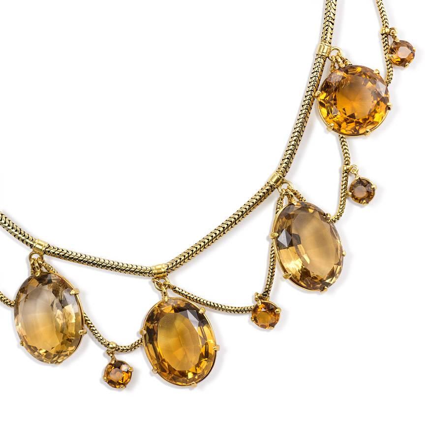 An antique gold and citrine festoon necklace on a snake chain, in 15k.  England.