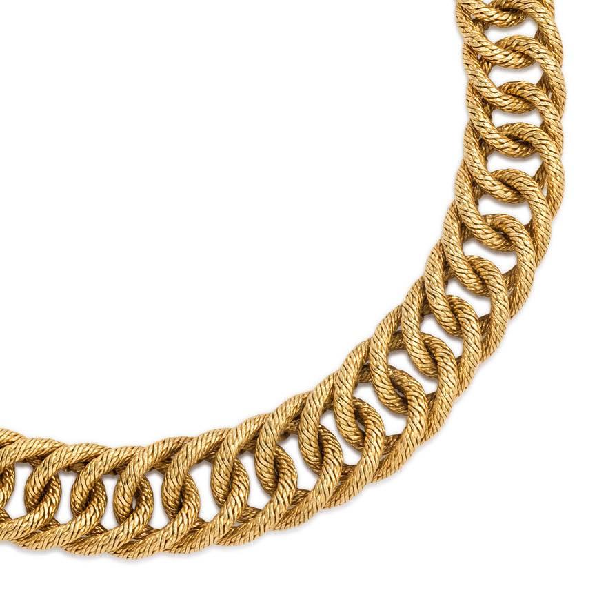 A woven gold necklace of tapering curblink design, in 18K. Georges L'Enfant, France.