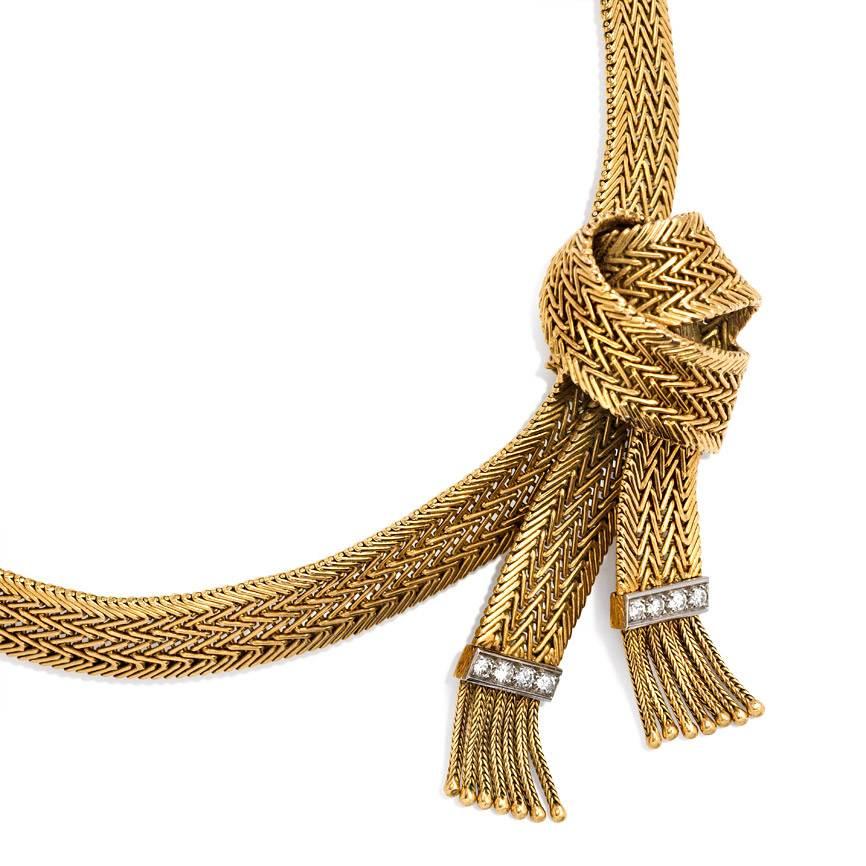 A flat weave gold necklace of knotted design with foxtail tassels and diamond embellishment, in 18K and platinum.  Gaucherand, Paris.