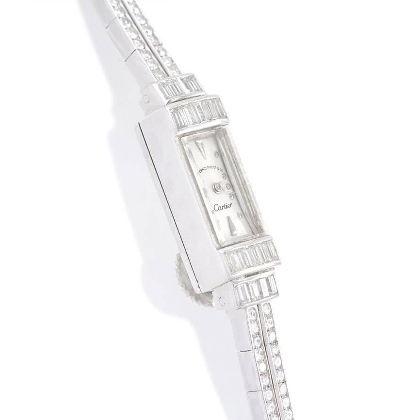 A diamond dress backwinder watch with a rectangular face and a double row line bracelet with baguette spacers, in platinum.  Audemars Piguet for Cartier.  Atw 2.48 cts.