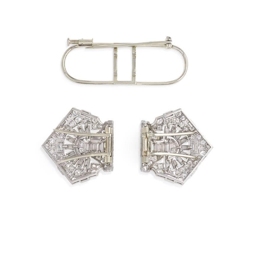 An Art Deco diamond brooch of geometric design which can be separated and worn as a pair of dress clips, in platinum with 18k white gold pin stems. France. Maker's poinçon for Georges Rochette.  Approx. 6.75 cts. tw.