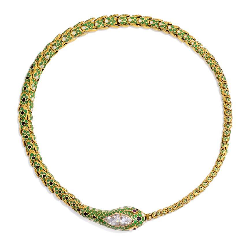 An antique gold necklace in the form of an ouroboros snake comprised of articulated scaled links with green, black and white enamel decoration and a rose diamond head with ruby eyes, in 18k. France