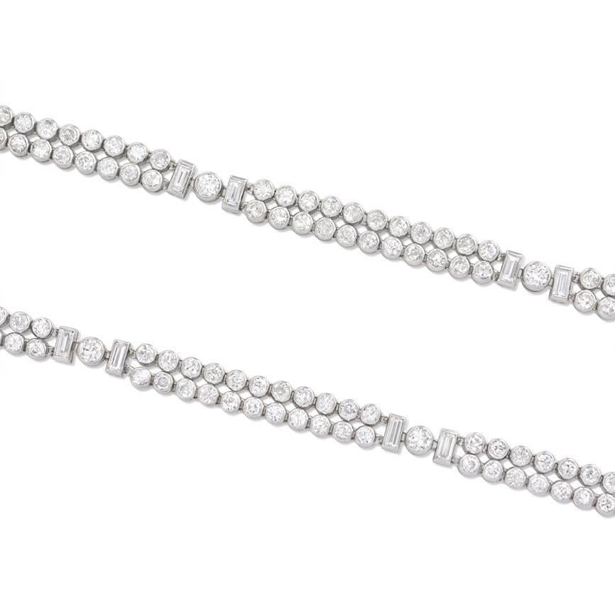 A pair of Art Deco diamond bracelets designed as four segments of collet-set double rows of round diamonds with baguette spacers, in platinum.  Approx. 11.60 cts. tw.  French import.  May be worn as a necklace.
