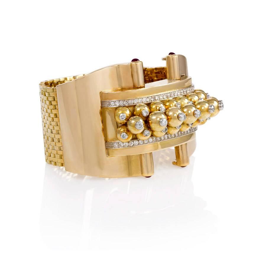 A Retro bracelet comprised of a wide, woven gold strap with a center panel of stacked gold and diamond beads, accented with ruby terminals. The bracelet is set with approx. 2.81 ct. tw. diamonds in 18k gold and platinum.  France.