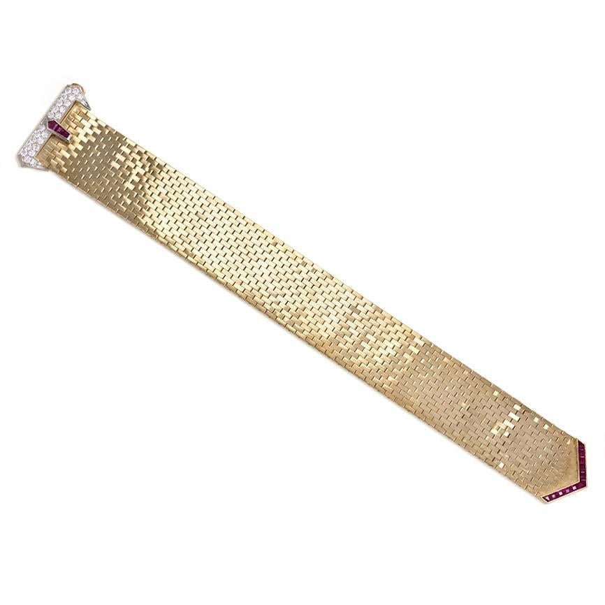A Retro gold brick link bracelet of belt strap design with calibre cut ruby and diamond-set buckle closure, in 14K.  Cartier.