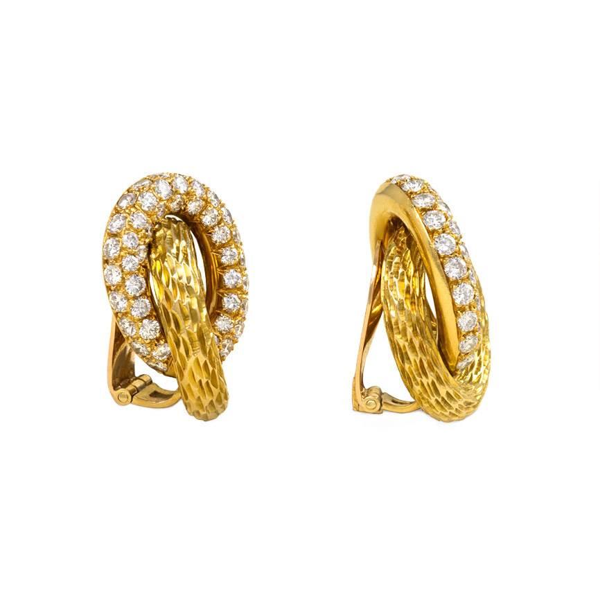 A pair of gold and pavé diamond earrings of interlocking oval design, in 18k. René Boivin, France. Atw. 5.20 ct. tw. diamonds.