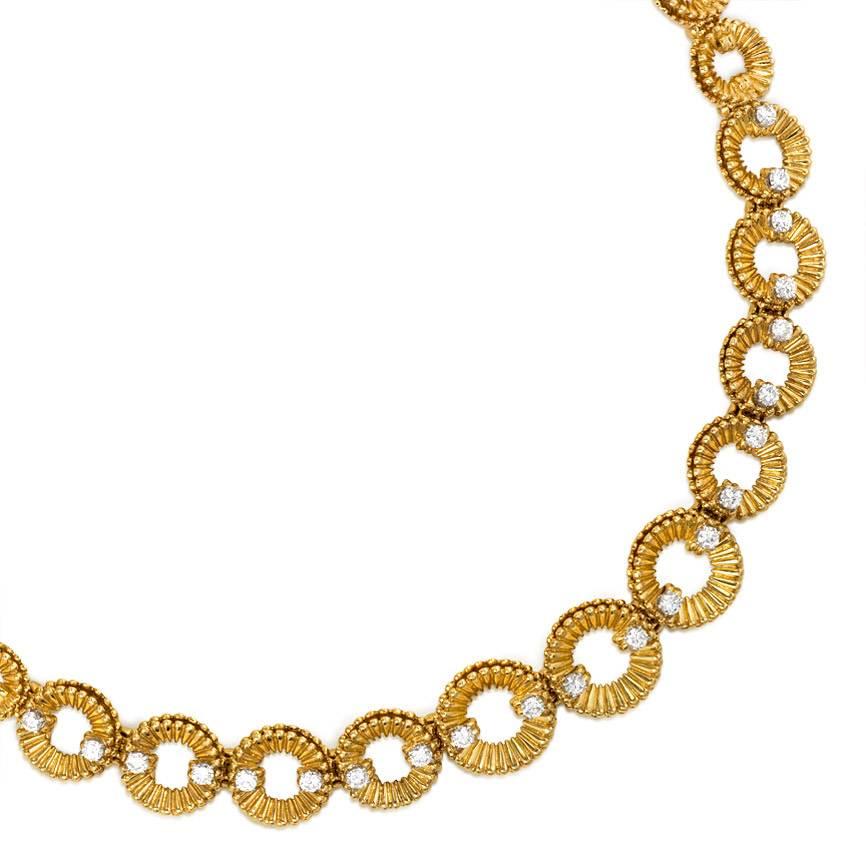 A gold necklace comprised of ribbed and doubled circular links set with diamonds, in 18K and platinum. Van Cleef & Arpels, France #81015.