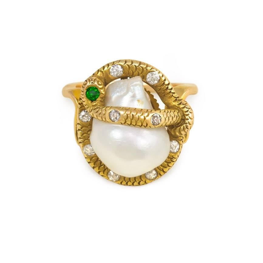 An antique gold ring comprised of a snake set with diamonds and a demantoid garnet entwined around a fresh water pearl, in 14k.  Numbered 10413.

Top measures approximately 1.8 x 1.7 cm.