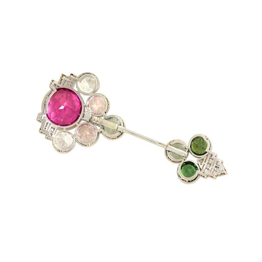 An Art Deco diamond and gemset jabot brooch of geometric design set with pink and green tourmalines, colorless zircons, morganites, aquamarines, and diamonds, in platinum.  France.