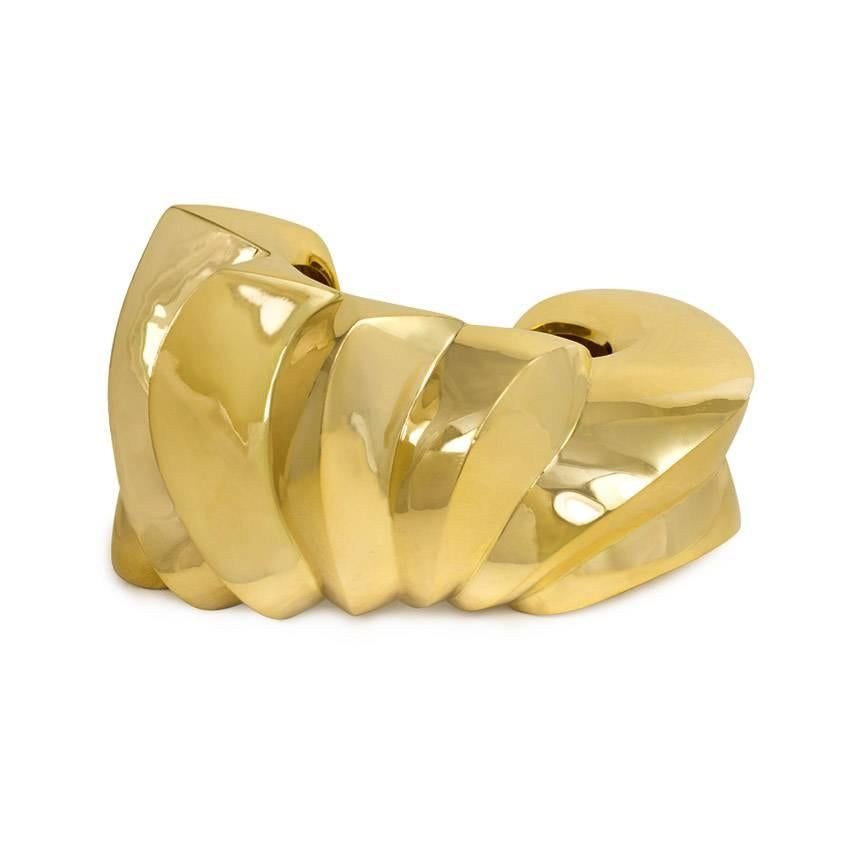 A large sculptural carved gold cuff bracelet of ridged design, in 18k. Italy

Inner circumference approximately 7"