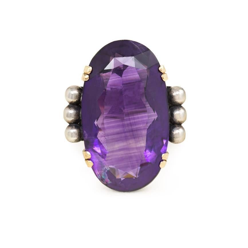 An Art Deco amethyst ring in the industrial style with beaded shoulders, in 18k gold and sterling silver.  Jean Després, France

Top of ring measures approximately 1 1/8" high