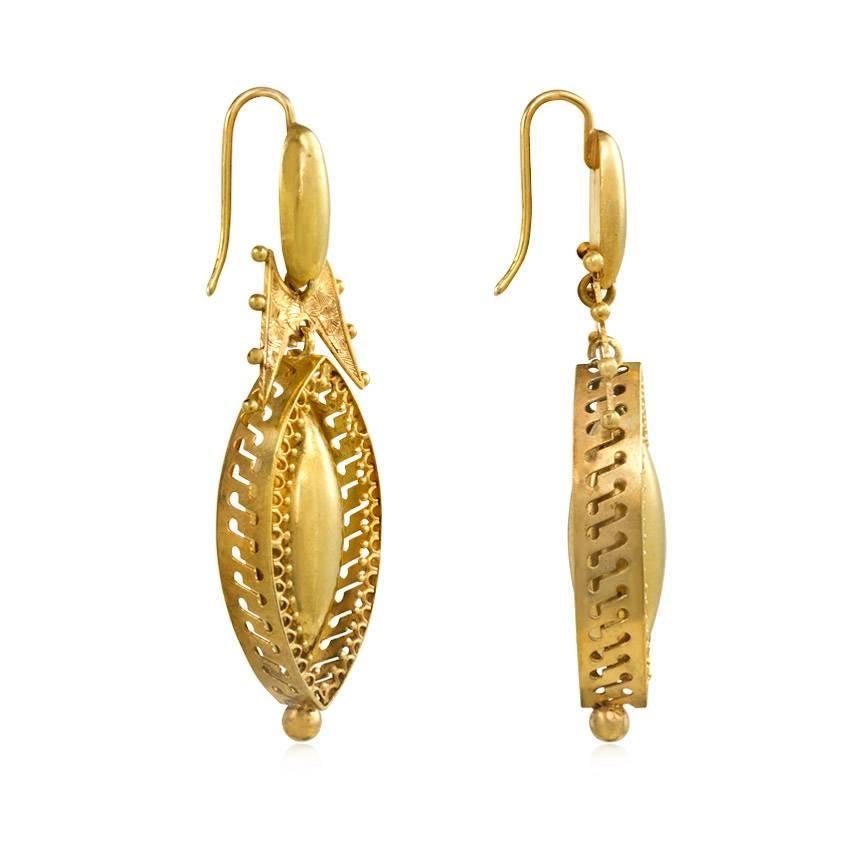 A pair of antique gold Etruscan revival earrings suspending navette-shaped drops in pierced frames with wirework-decorated edges, in 18k.

1 7/8" long, including top of wire