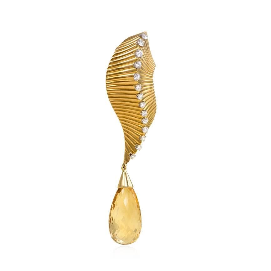 A Retro gold brooch in the form of a stylized leaf, adorned with graduated diamonds and suspending a briolette-cut citrine, in 18K.  Cartier, Paris, #13008(/1).  Atw. 0.60 ct. diamonds.