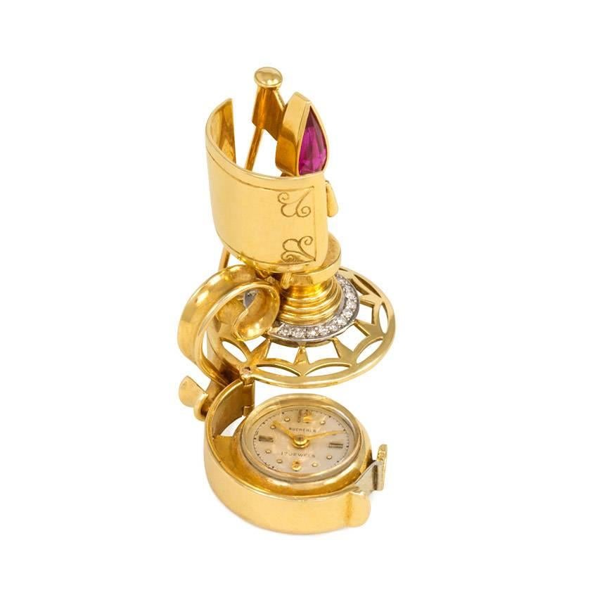 A Retro gold, diamond and synthetic ruby brooch in the form of a candlestick with a hidden watch, 18k. Bucherer, Switzerland #35181