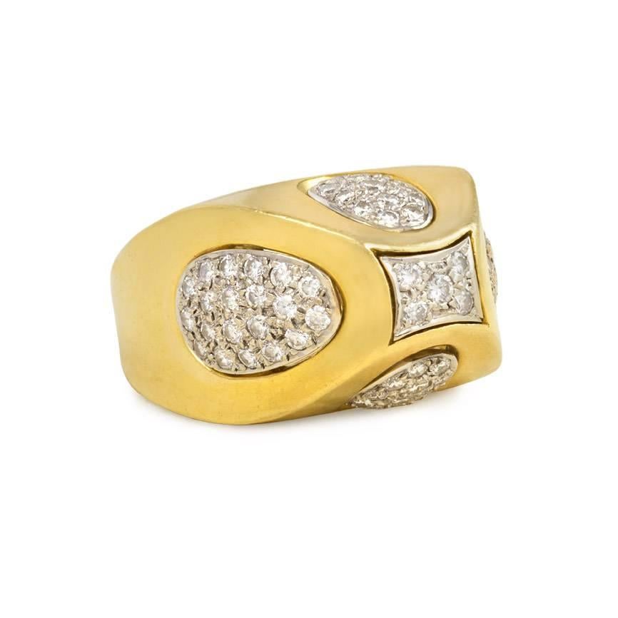 A gold ring in the form of a sugarloaf with geometric diamond inserts, in 18K and platinum.

Top dimensions: 5/8 x 7/8", sits approximately 1/2" above hand