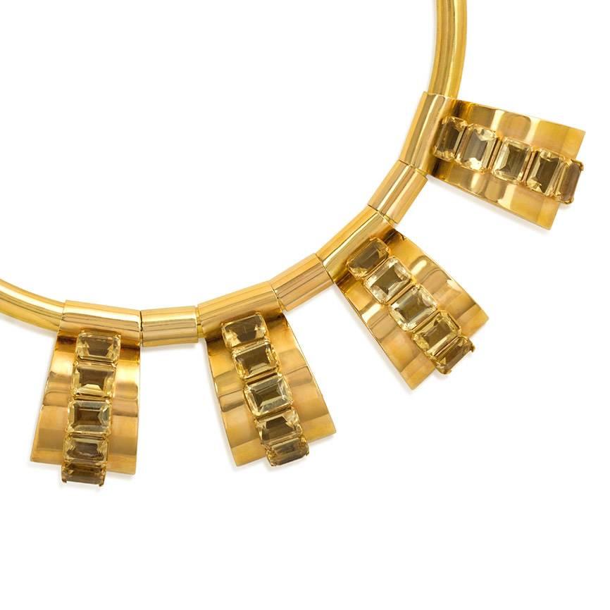 A Retro gold necklace comprised of a torque suspending four semicircular panels set with citrines, in 18k.

Approximately 14 1/2" long, each pendant: 1 3/16"