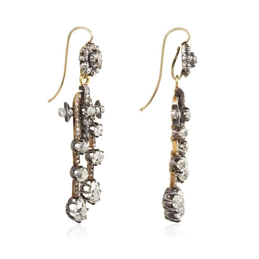 A pair of antique old mine diamond earrings with cluster-form tops suspending négligée-style pendants, in 18K gold and silver.  Atw. 5.24 cts.