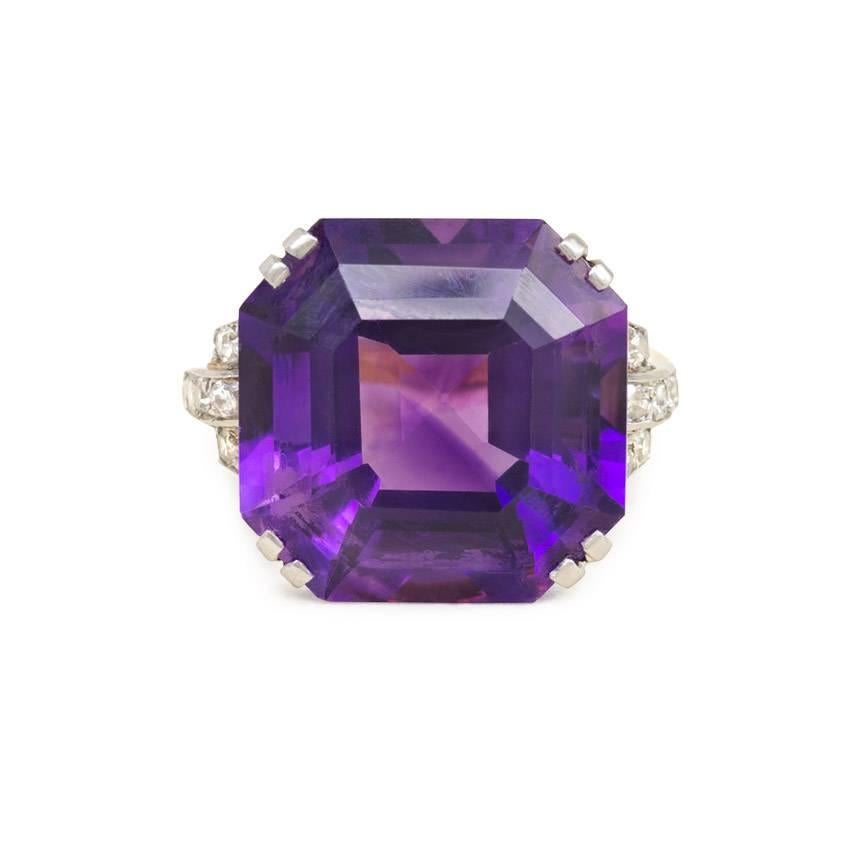 A Retro cocktail ring centering on a large octagonal amethyst, with diamond-set shoulders and openwork mount, in 18k gold and platinum.

Top approximately 5/8x5/8"