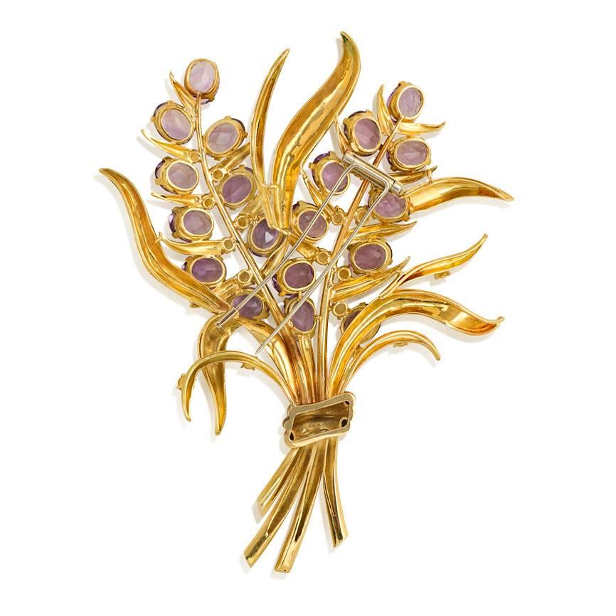 A Retro oversized gold, amethyst, and citrine brooch in the form of a stylized flower bouquet, in 18k.