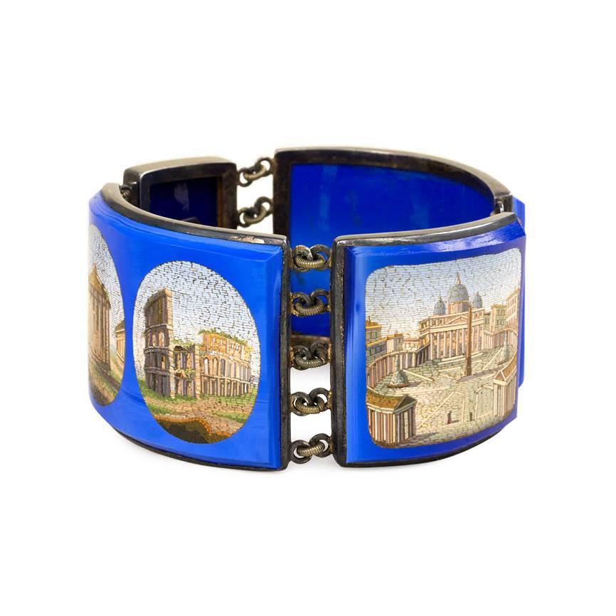 A superb antique micromosaic bracelet comprised of four panels depicting architectural sites, set into blue glass and connected by reeded links, in sterling silver. Original bespoke, fitted leather case