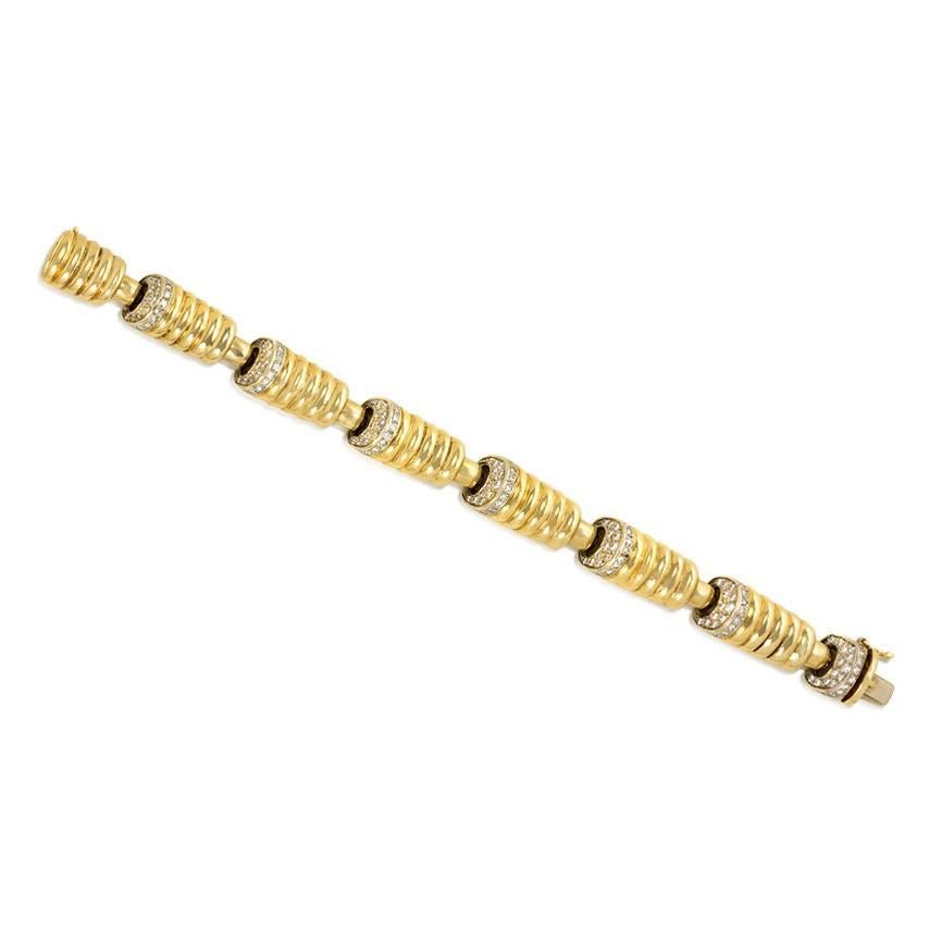 A gold and diamond bracelet of ribbed oblong links, each link embellished on one end with an angled surface of diamonds, in 18k.  Rome, Italy.  Atw diamonds 2.00 cts.

Please feel free to contact Kentshire for additional photos of details or of the