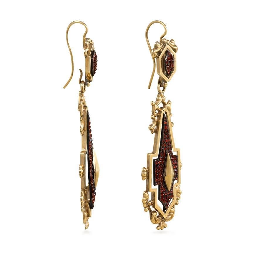 A pair of antique repoussé gold day-to-night earrings with floating garnet-set steel panels and gold kite-shaped appliqués, in 18k