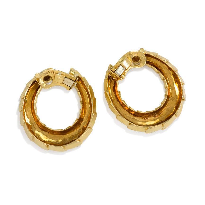 A pair of gold hoop earrings of scaled and slightly tapered design, in 18k.  Cartier. #28112