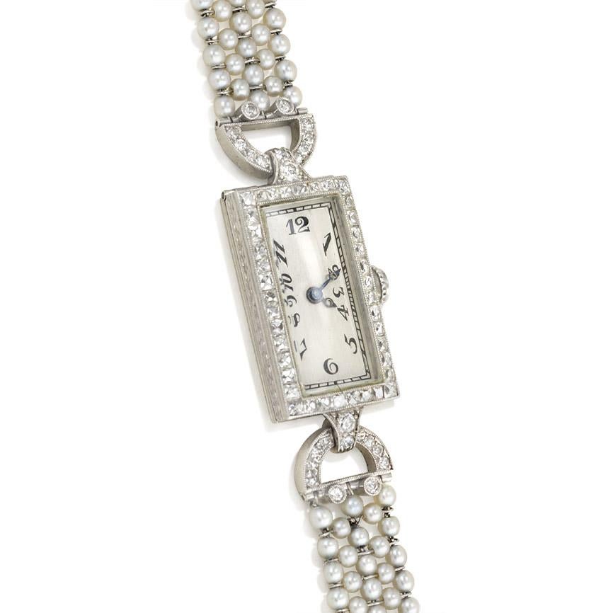 An Art Deco wrist watch comprised of a rectangular face with a French-cut diamond surround on a seed pearl strap with a faceted onyx and diamond closure, in platinum.  Movement, C.H. Meylan.  Atw. 1.21 ct. French cut, full cut, single cut, and rose