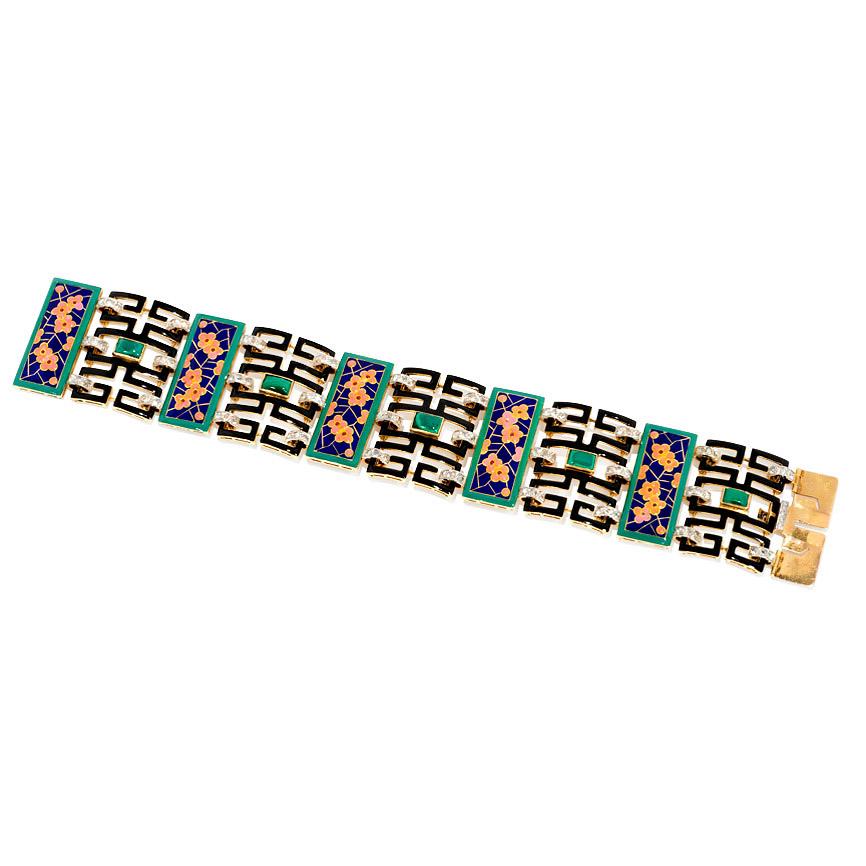 An Art Deco gold and multi-colored enamel Chinoiserie bracelet composed of five champlevé enameled rectangular panels of pink blossoms against a blue and gold ground framed in green, alternating with black enameled openwork panels with malachite