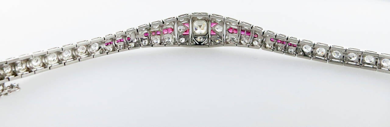 Handmade platinum mount Art Deco diamond and calibre ruby Art Deco bracelet.The center is set with an old Asscher cut diamond measuring 6.3mm. x 5.7mm weighing approx 1.35cts. grading J- K color VS clarity. The mount is bead set with 72 round