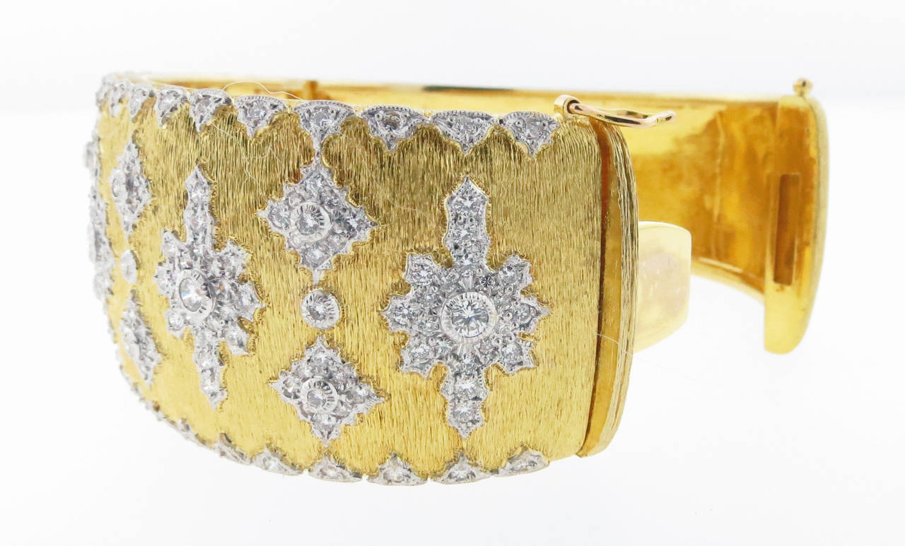 Heavy 18kt 1 inch wide diamond bangle bracelet  weighing a very impressive 101.7gr. The matt bark finish bracelet is bead set across the top in white gold with 205 round brilliant cut diamonds totaling approx 2.25cts. Hidden catch.