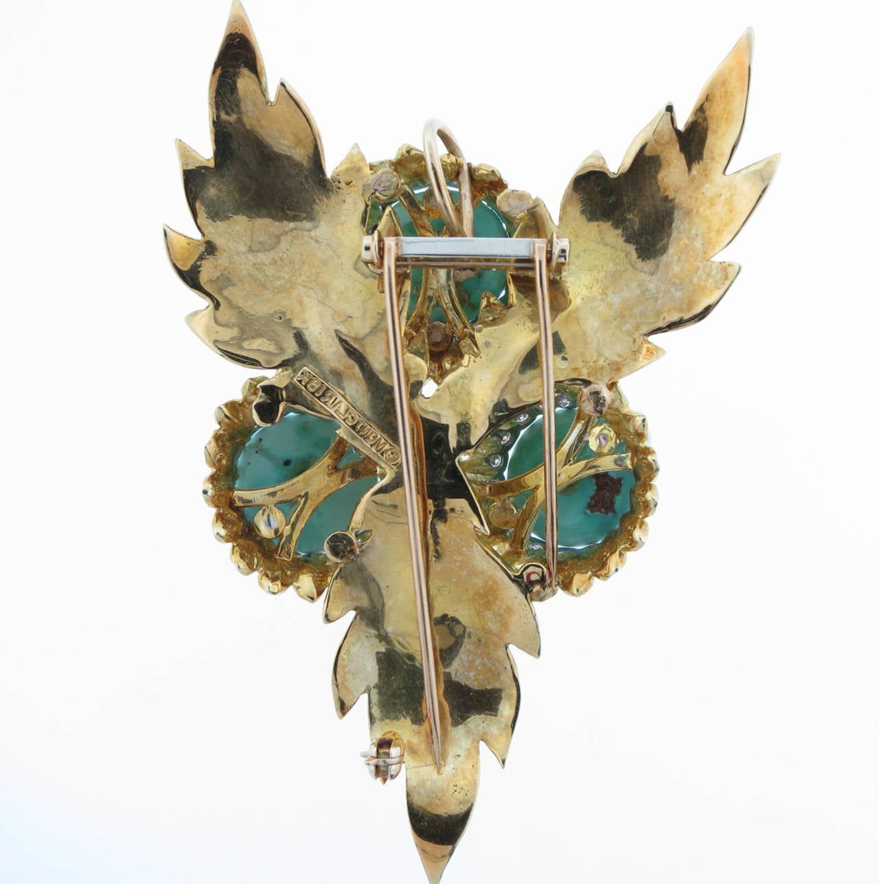 Perfect for summer ! The mounting is 18kt. yellow gold and designed in a floral  motif. Each turquoise measures 13. mm. and is surrounded in white gold and bead set with 19 round brilliant cut diamonds. Total diamond weight approx .65cts. The brooch