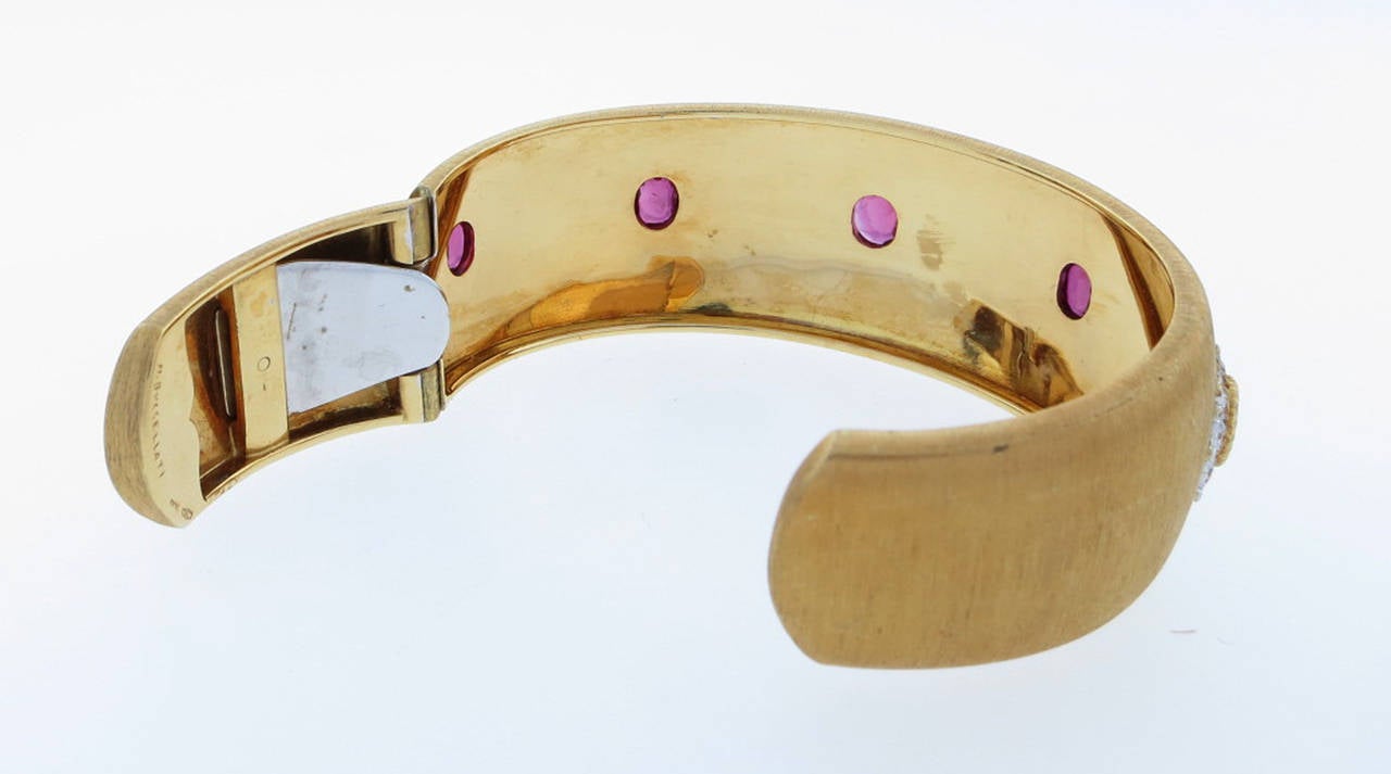 A everlasting classic Buccellati cuff bracelet circa 1960. The 18kt. yellow gold with white gold decorations. The bracelet measures approx 1 inch wide and is bezel set with five oval faceted garnets. The cuff will fit most wrists. Signed.