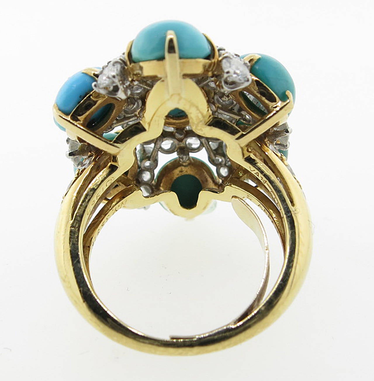 High Style 18kt. yellow gold turquoise and diamond ring by VAN CLEEF & ARPELS. The center is prong set with an oval natural turquoise measuring 9.8mm. x 8.7mm. surrounded by 6 round cabachon turquoise each measuring approx 7.mm. The exquisitely made