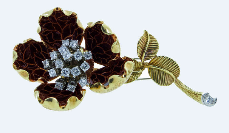 Van Cleef & Arpels 18kt. yellow gold flower brooch with dark reddish enamel petals. The  tremblant center is prong set in white gold with 16 round brilliant cut diamonds  totaling approximately 1.1 carats. The stem bottom is also set with a round