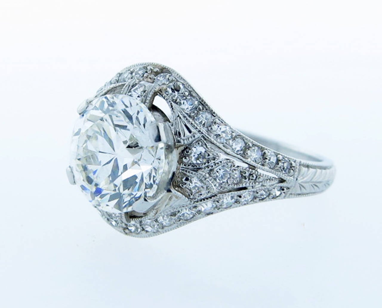 Scintillating handmade platinum mount diamond ring by the renowned American jeweler Marcus. The center is prong set with a round  European cut diamond measuring approx 7.8 mm. x 5.5 mm. weighing 2.32 cts. The diamond grades VS clarity and faces up 