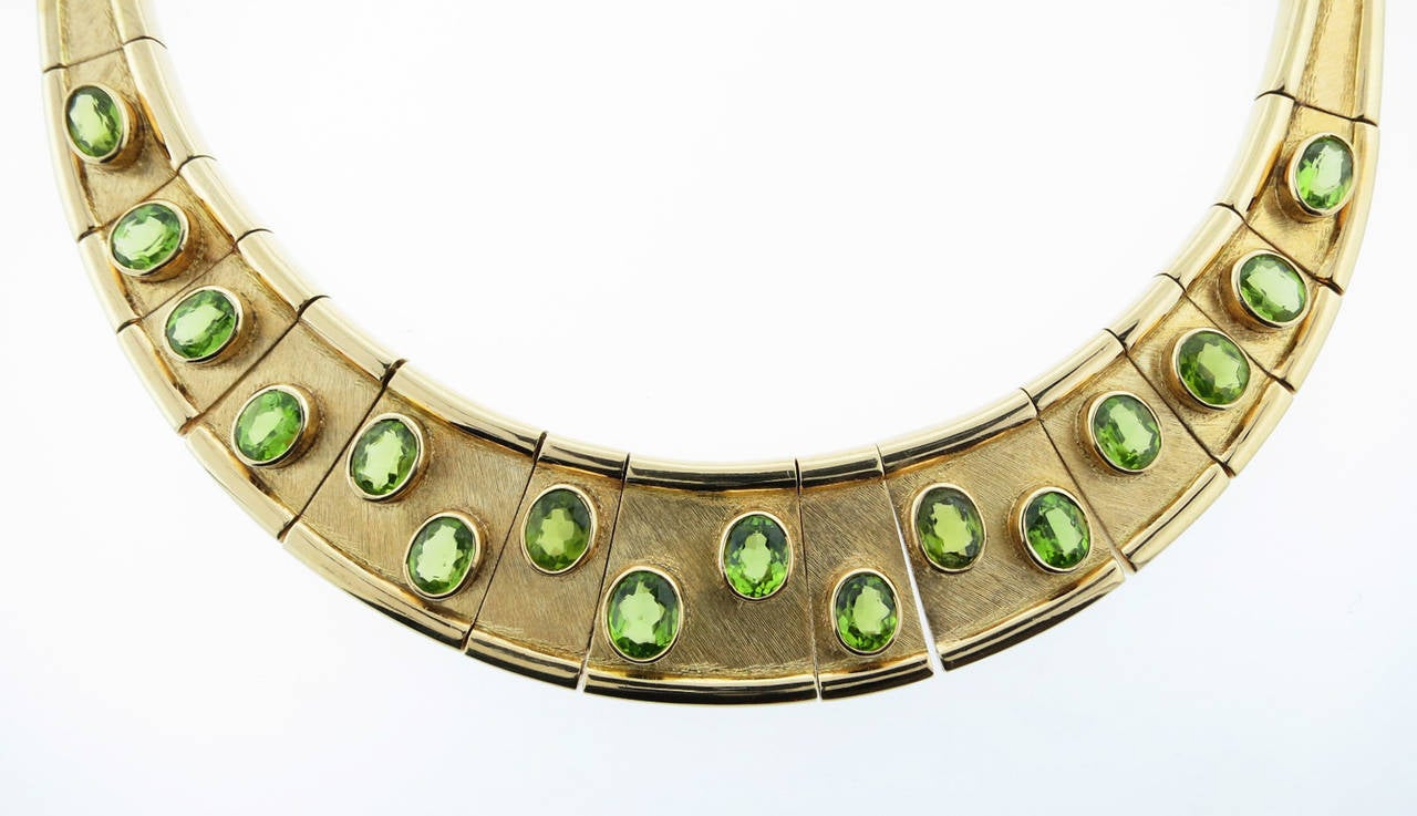 Burle Marx graduating sand and high polish edged 18kt. yellow gold link collar necklace. The necklace graduates to one inch at the front, and is bezel set with seventeen faceted natural peridots, totaling approx. 20cts. Signed by the esteemed