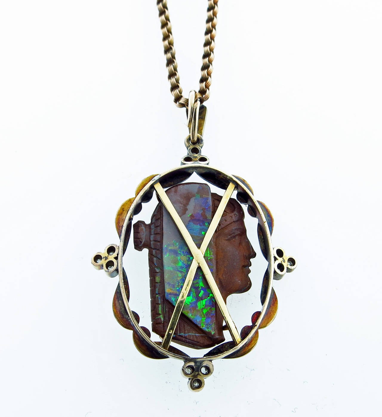 A work of art in carved boulder opal cameo, the antique pendant is finely detailed on both sides and measures 1 3/4
