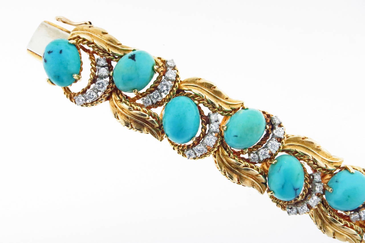 18kt yellow gold leaf design bracelet by Hammerman Brothers circa 1950. The bracelet is set with 14 oval cabochon turquoise prong set in platinum with 70 round brilliant cut diamonds totaling approx 2.5cts. grading VS clarity G color. The bracelet
