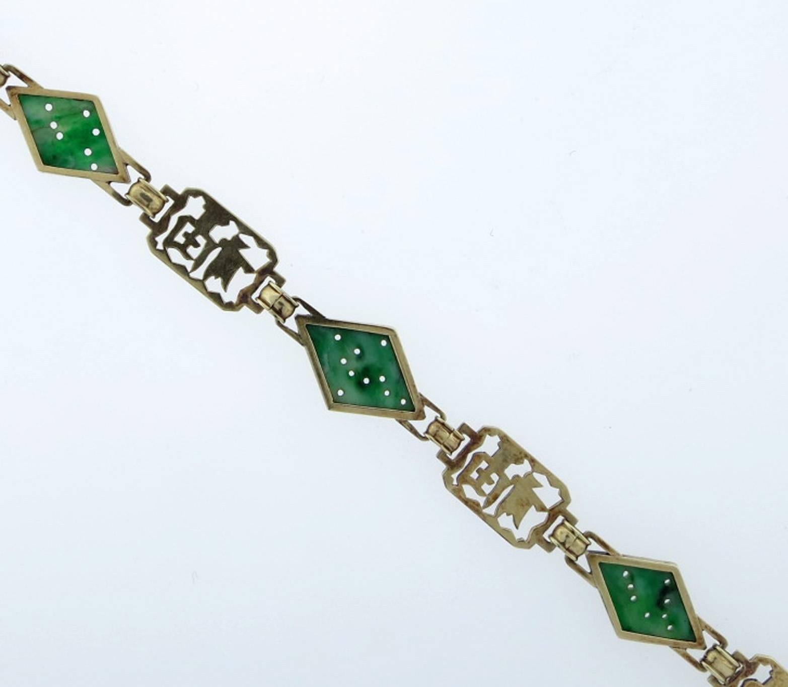 14kt. yellow gold link bracelet with green and black enamel Chinese symbols for a long and happy life with three marquise shape carved jade pieces. The bracelet measures approx 7.5cts. Circa 1930.